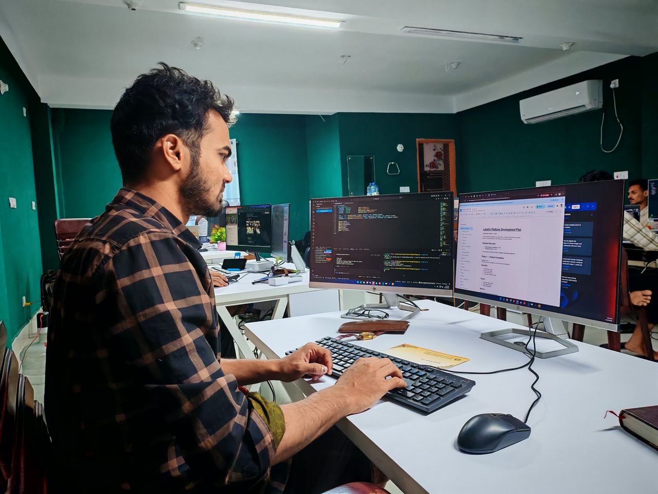 Crafting Captivating Headlines: Your awesome post title goes here A software developer working on code at a dual monitor setup in a modern office.
