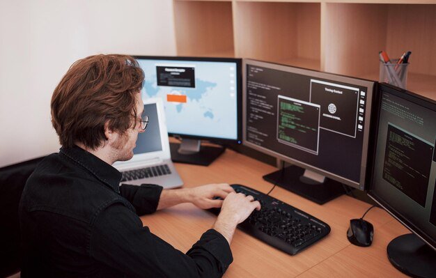 male-programmer-working-desktop-computer-with-many-monitors-office-software-develop-company-website-design-programming-coding-technologies-1040180-7096
